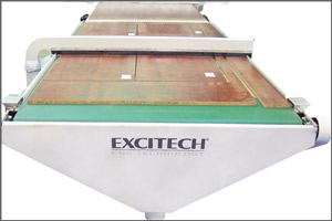 The front conveyor includes a down draft vacuum trough