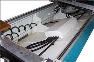 Angled debris trough with access ports in the front of the machine